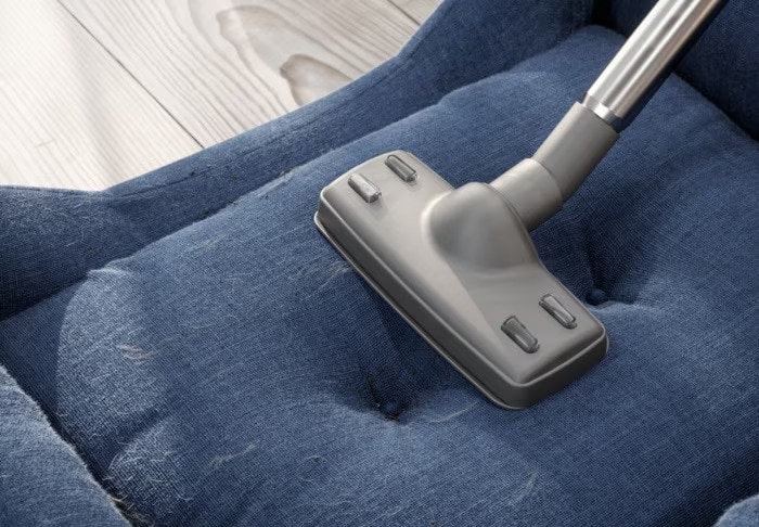 clean-fabric-sofa-with-vacuum-cleaner-at-home-1