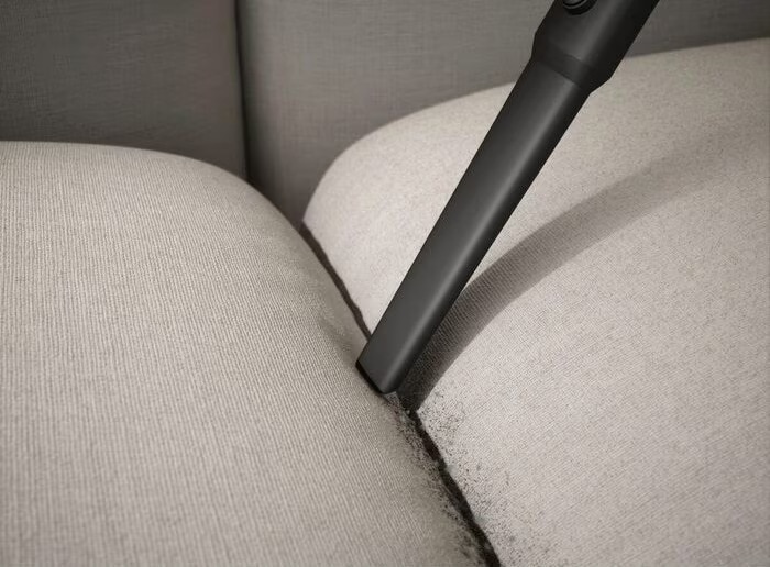 clean-fabric-sofa-with-vacuum-cleaner-at-home-2