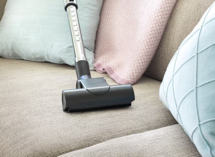 clean-fabric-sofa-with-vacuum-cleaner-at-home-3
